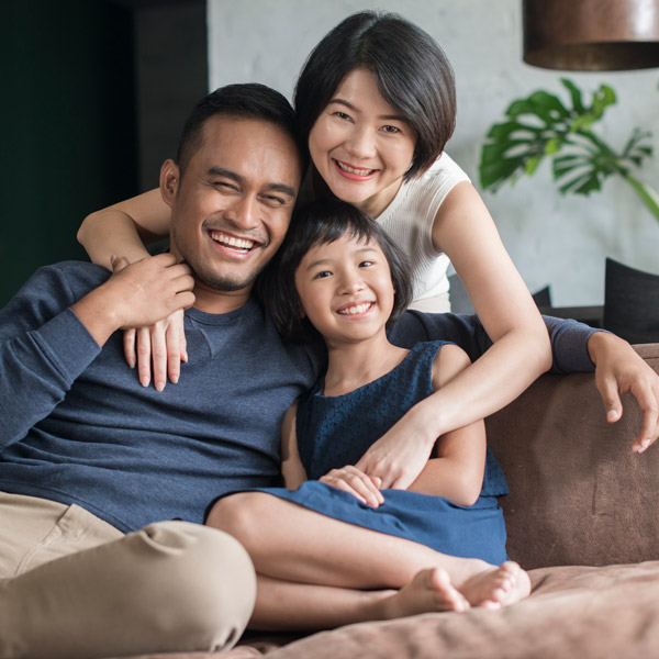asian family smiling on the couch