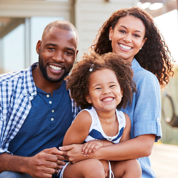 african-american family dressed in blue and white similing